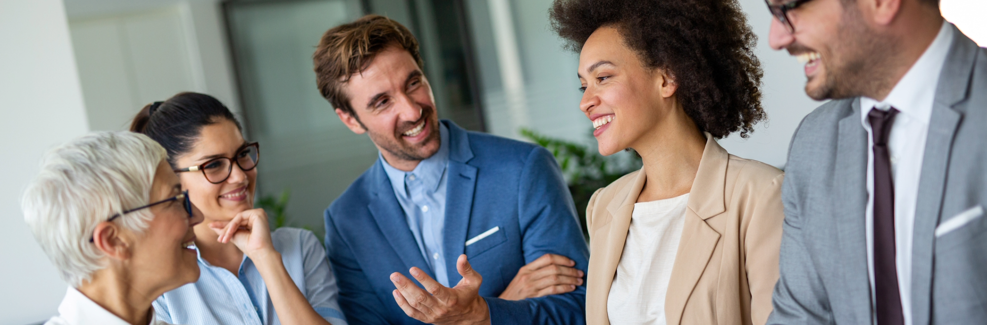 A diverse group of colleagues smiling at each other building connections.