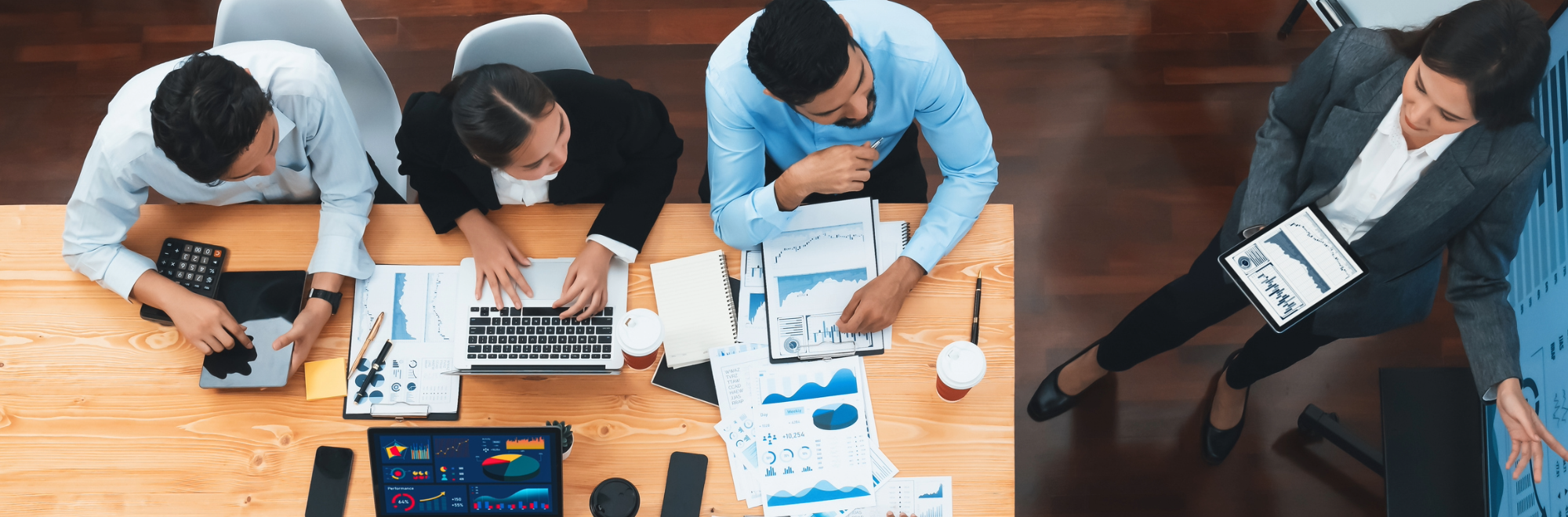 Leadership team in goal setting and planning meeting looking over analytics